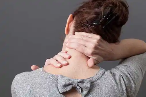woman holding her neck in pain